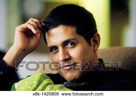 A man twirls his hair View Large Photo Image Stock Photo - A man twirls his hair. Fotosearch