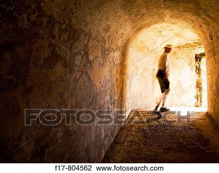 a man walking into the light at the end of a tunnel. View Large Photo Image Stock Image - a man walking into the light at the end of a tunnel.. Fotosearch