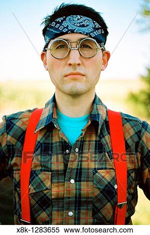 A man wearing bomber glasses, a bandana, flannel, and suspenders View Large Photo Image Stock Photography - A man wearing bomber glasses, a bandana, flannel, and suspenders. Fotosearch