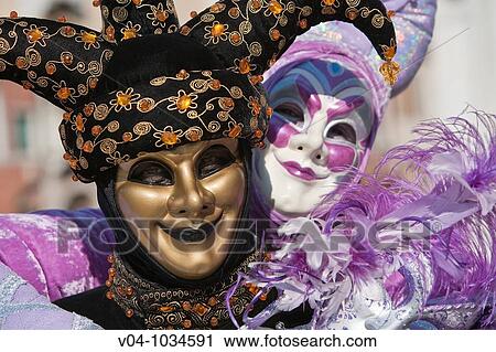 Stock Image - A masked couple looking affectionately at each other at the carnival in Venice, Italy, Europe. Fotosearch