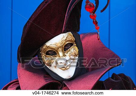 Picture - A masked harlequin at the carnival in Venice, Italy, Europe. Fotosearch