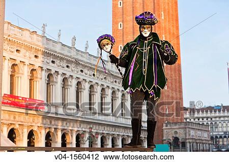 Stock Image - A masked harlequin at the carnival in Venice, Italy, Europe. Fotosearch