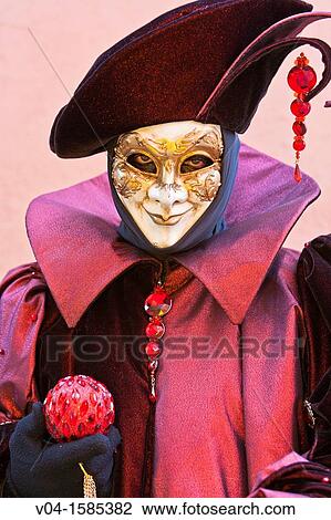 Stock Image - A masked harlequin at the carnival in Venice, Italy, Europe. Fotosearch