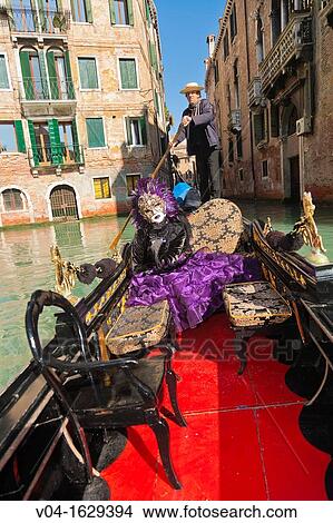 A masked woman during carnival in a gondola, Venice, Italy, Europe View Large Photo Image Picture - A masked woman during carnival in a gondola, Venice, Italy, Europe. Fotosearch