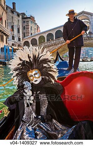 A masked woman during carnival in a gondola on the Canale Grande, Venice, Italy, Europe View Large Photo Image Stock Photo - A masked woman during carnival in a gondola on the Canale Grande, Venice, Italy, Europe. Fotosearch