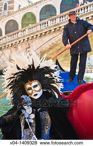 A masked woman during carnival in a gondola on the Canale Grande, Venice, Italy, Europe View Large Photo Image Stock Photo - A masked woman during carnival in a gondola on the Canale Grande, Venice, Italy, Europe. Fotosearch