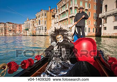A masked woman during carnival in a gondola on the Canale Grande, Venice, Italy, Europe View Large Photo Image Stock Photograph - A masked woman during carnival in a gondola on the Canale Grande, Venice, Italy, Europe. Fotosearch