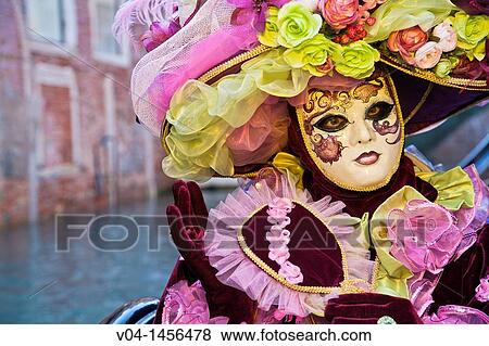 Stock Photo - A masked woman in a gondola at the carnival in Venice, Italy, Europe. Fotosearch