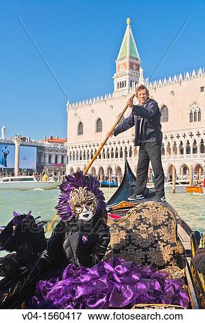 A masked woman in a gondola with the Palazzo Ducale in the background at the carnival in Venice, Italy, Europe View Large Photo Image Stock Photo - A masked woman in a gondola with the Palazzo Ducale in the background at the carnival in Venice, Italy, Europe. Fotosearch
