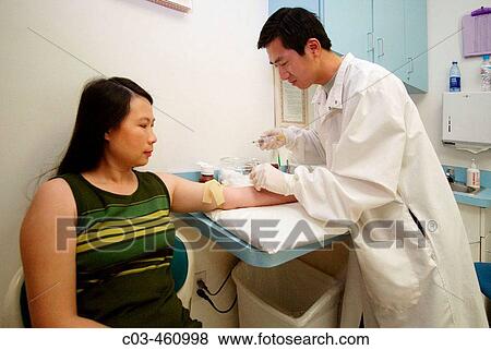 A medical technician prepares to administer an injection at a neighborhood health clinic in a Vietnamese section of Fullerton, California View Large Photo Image Stock Photo - A medical technician prepares to administer an injection at a neighborhood health clinic in a Vietnamese section of Fullerton, California. Fotosearch