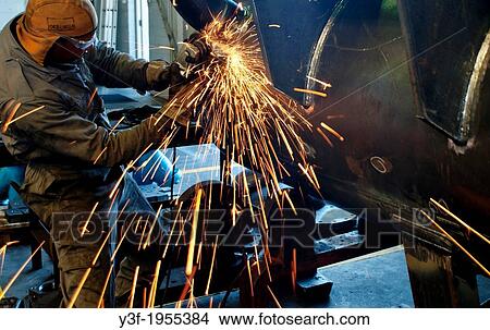 A metal grinder cuts through a steel pipe as sparks fly View Large Photo Image Picture - A metal grinder cuts through a steel pipe as sparks fly. Fotosearch