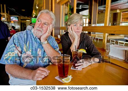 A middle aged couple appeared indifferent to each others? company over iced tea together in a Long Beach, CA, restaurant View Large Photo Image Stock Photo - A middle aged couple appeared indifferent to each others? company over iced tea together in a Long Beach, CA, restaurant. Fotosearch
