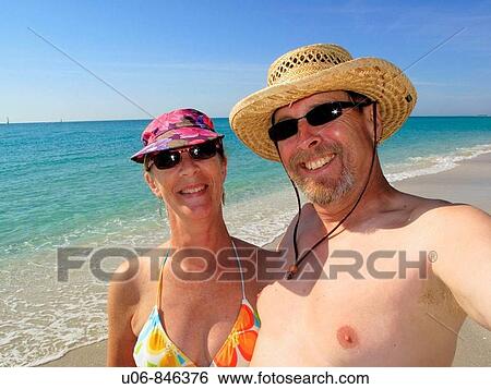 a middle aged couple at the beach in bathing suits View Large Photo Image Stock Photograph - a middle aged couple at the beach in bathing suits. Fotosearch
