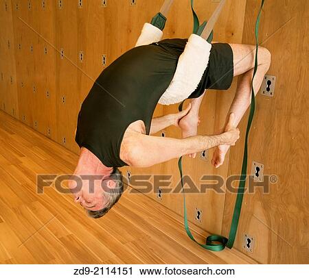 A middle-aged man demonstrates an ashtanga yoga pose on the yoga wall. View Large Photo Image Stock Image - A middle-aged man demonstrates an ashtanga yoga pose on the yoga wall.. Fotosearch