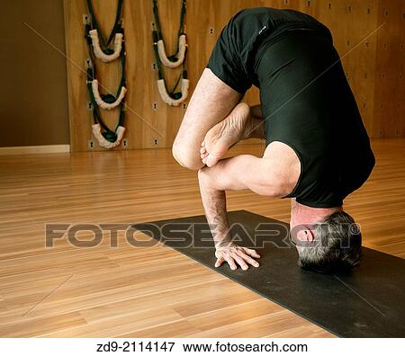 A middle-aged man demonstrates an ashtanga yoga pose. View Large Photo Image Stock Photo - A middle-aged man demonstrates an ashtanga yoga pose.. Fotosearch