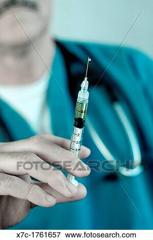Stock Photo - A middle-aged white caucasion man serving as a professional, doctor, veterinarian. Fotosearch