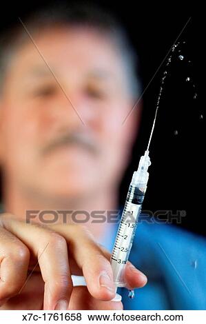 A middle-aged white caucasion man serving as a professional, doctor, veterinarian View Large Photo Image Stock Photo - A middle-aged white caucasion man serving as a professional, doctor, veterinarian. Fotosearch