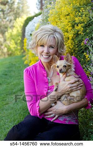 A middle-aged woman with a chihuahua View Large Photo Image Stock Image - A middle-aged woman with a chihuahua. Fotosearch