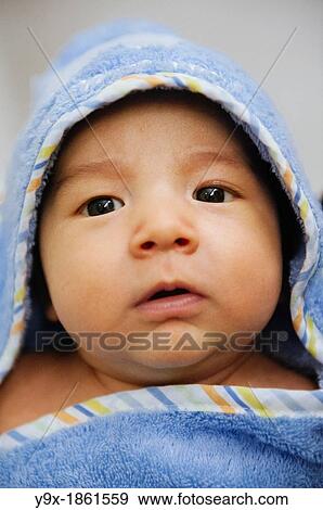A mixed ethnicity baby wrapped in a blue towel blanket View Large Photo Image Stock Photo - A mixed ethnicity baby wrapped in a blue towel blanket. Fotosearch