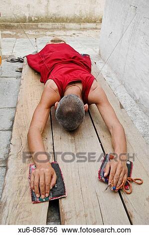 A monk prostrating at boudhanath stupa Nepal View Large Photo Image Stock Photograph - A monk prostrating at boudhanath stupa Nepal. Fotosearch