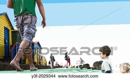 A montage and photo graphic bathing boxes/change cubicles, and passers by at the beach. Montage and digital effects. View Large Photo Image Picture - A montage and photo graphic bathing boxes/change cubicles, and passers by at the beach. Montage and digital effects.. Fotosearch