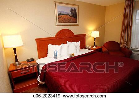 A motel hotel room in the USA showing a king size bed View Large Photo Image Stock Photo - A motel hotel room in the USA showing a king size bed. Fotosearch