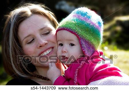 Stock Photo - A mother and her infant daughter outdoors. Fotosearch