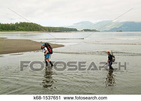 a mother and her son, 9, cross a stream on Nootka Island, BC, Canada View Large Photo Image Stock Image - a mother and her son, 9, cross a stream on Nootka Island, BC, Canada. Fotosearch