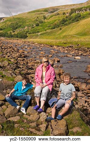 A mother and her two sons at the river Swale at Muker in Swaledale in North Yorkshire, England, Britain, Uk View Large Photo Image Stock Photo - A mother and her two sons at the river Swale at Muker in Swaledale in North Yorkshire, England, Britain, Uk. Fotosearch