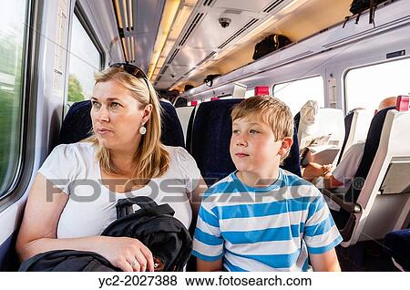 Stock Photo - A mother and son travelling by train in the Uk.. Fotosearch