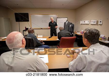 A motivational speaker lectures at a "Men's Career Workshop" on new business attire from Working Wardrobes, a organization helping the unemployed dress and groom for successful business job interviews in Southern California. MODEL RELEASE. View Large Photo Image Stock Image - A motivational speaker lectures at a "Men's Career Workshop" on new business attire from Working Wardrobes, a organization helping the unemployed dress and groom for successful business job interviews in Southern California. MODEL RELEASE.. Fotosearch