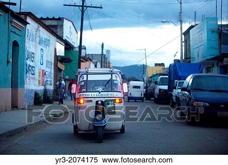 A motorcycle taxi decorated with crosses for the Day of the Dead drives in Ocotlan de Morelos, Oaxaca, Mexico. The Day of the Dead celebration is a tradition that honors the deceased. View Large Photo Image Stock Photography - A motorcycle taxi decorated with crosses for the Day of the Dead drives in Ocotlan de Morelos, Oaxaca, Mexico. The Day of the Dead celebration is a tradition that honors the deceased.. Fotosearch