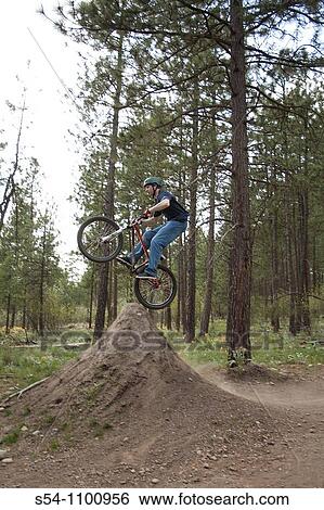 A mountain biker riding over jumps at Camp Sekani Park, Beacon Hill, Spokane, Washington, USA View Large Photo Image Stock Photograph - A mountain biker riding over jumps at Camp Sekani Park, Beacon Hill, Spokane, Washington, USA. Fotosearch