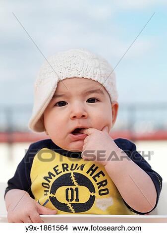 A multi ethnic baby boy poses with a funny knit hat View Large Photo Image Picture - A multi ethnic baby boy poses with a funny knit hat. Fotosearch