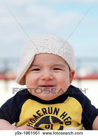 A multi ethnic baby boy poses with a funny knit hat View Large Photo Image Stock Image - A multi ethnic baby boy poses with a funny knit hat. Fotosearch