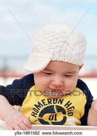 A multi ethnic baby boy poses with a funny knit hat View Large Photo Image Stock Image - A multi ethnic baby boy poses with a funny knit hat. Fotosearch