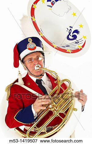 A musician from Corpo Musicale Caronno Pertusella musical band playing a sousaphone The artist wear the musical band uniform and is isolated on white View Large Photo Image Stock Photo - A musician from Corpo Musicale Caronno Pertusella musical band playing a sousaphone The artist wear the musical band uniform and is isolated on white. Fotosearch