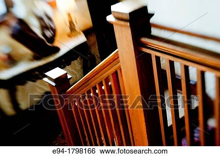 A narrow depth of field photo of a bannister railing on a staircase in a home. View Large Photo Image Stock Photograph - A narrow depth of field photo of a bannister railing on a staircase in a home.. Fotosearch