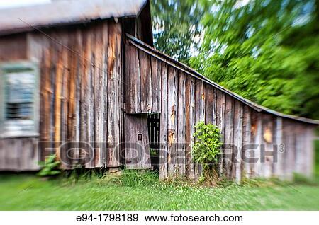 A narrow depth of field photo of the side of an old weathered barn with a small door partially opened. View Large Photo Image Stock Photo - A narrow depth of field photo of the side of an old weathered barn with a small door partially opened.. Fotosearch