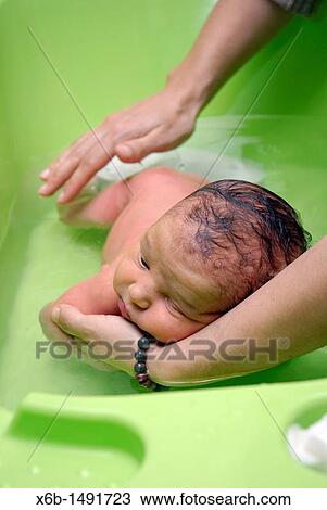 A newborn baby being bathed in the face down position View Large Photo Image Stock Image - A newborn baby being bathed in the face down position. Fotosearch