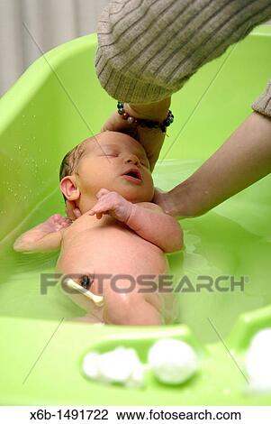 A newborn baby being bathed View Large Photo Image Stock Image - A newborn baby being bathed. Fotosearch