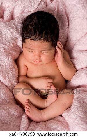 A newborn baby lies sleeping Lots of hair View Large Photo Image Stock Image - A newborn baby lies sleeping Lots of hair. Fotosearch