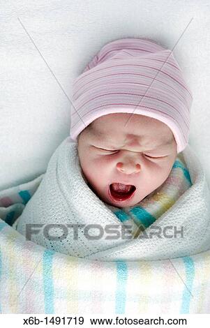 A newborn baby swaddled in blankets View Large Photo Image Stock Photo - A newborn baby swaddled in blankets. Fotosearch