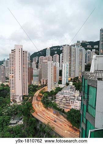 A nighttime view of the skyline of Central, Hong Kong, with lights from passing cars View Large Photo Image Stock Image - A nighttime view of the skyline of Central, Hong Kong, with lights from passing cars. Fotosearch