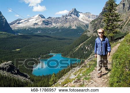 A nine year old boy hikes in the Lake O? Hara area of Yoho National Park, British Columbia, Canada View Large Photo Image Stock Photo - A nine year old boy hikes in the Lake O? Hara area of Yoho National Park, British Columbia, Canada. Fotosearch