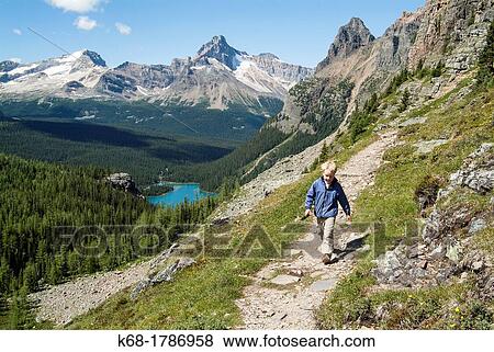 Stock Photo - A nine year old boy hikes in the Lake O? Hara area of Yoho National Park, British Columbia, Canada. Fotosearch