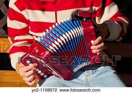 A nine year old boy playing an accordian in a Uk garden View Large Photo Image Stock Image - A nine year old boy playing an accordian in a Uk garden. Fotosearch