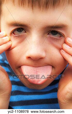A nine year old boy pulling a silly face in the Uk View Large Photo Image Stock Photo - A nine year old boy pulling a silly face in the Uk. Fotosearch