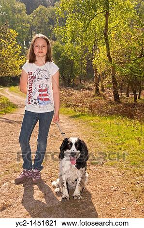 A nine year old girl walking the dog in the woods at Westleton Heath, Suffolk, England, Britain, Uk View Large Photo Image Stock Image - A nine year old girl walking the dog in the woods at Westleton Heath, Suffolk, England, Britain, Uk. Fotosearch