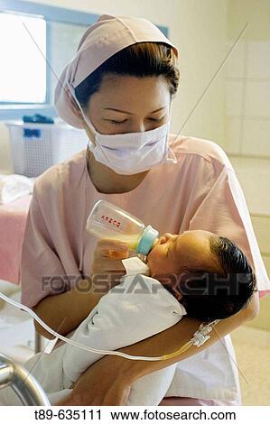 A nurse cares for a newborn in a Khon Kaen hospital. Thailand View Large Photo Image Stock Image - A nurse cares for a newborn in a Khon Kaen hospital. Thailand. Fotosearch